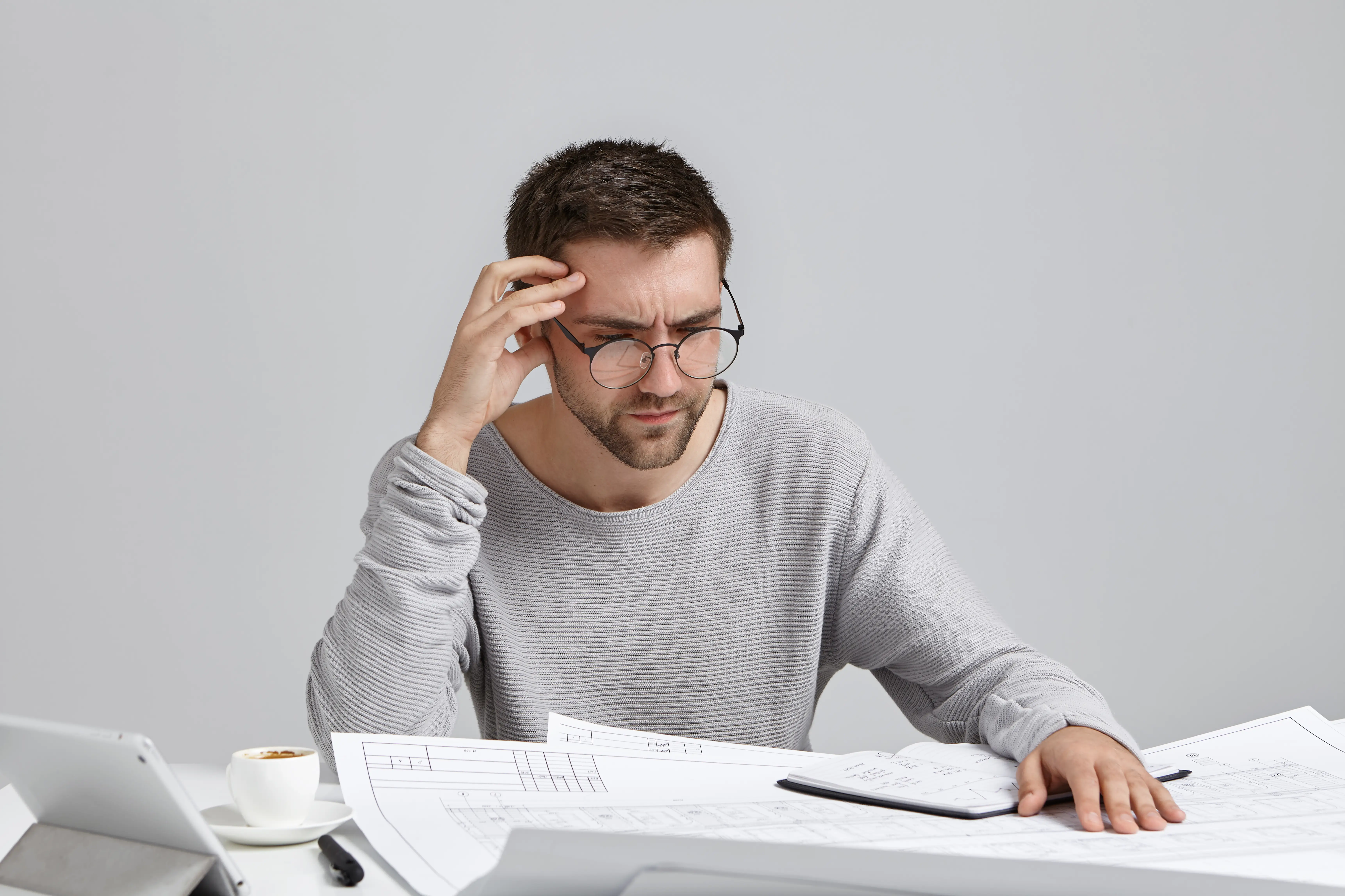 clever-male-creative-worker-tries-concentrate-drawings-doesn-t-understand-where-is-his-mistake.webp